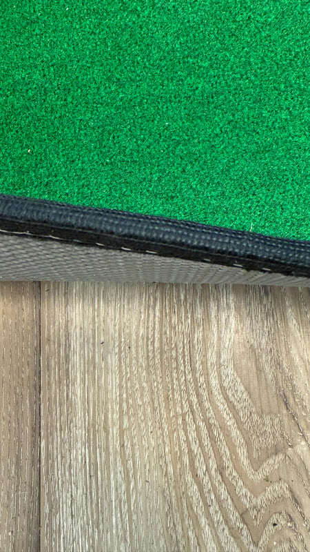 Wedge Game putting mat thickness showing on a wood floor