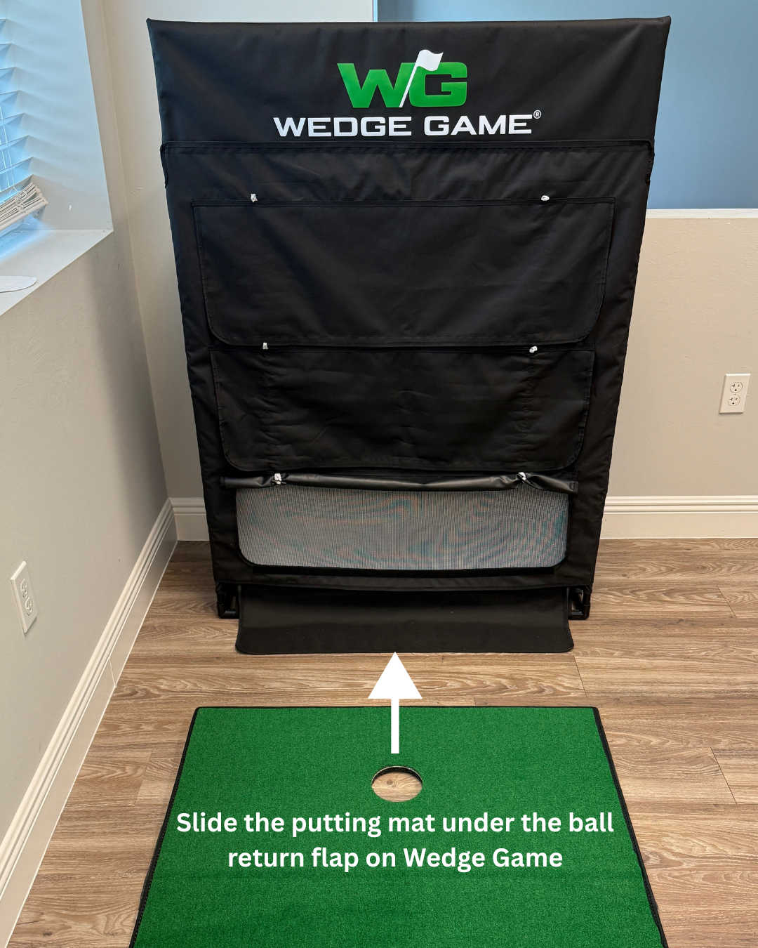 Wedge Game golf practice device with a green putting mat on a wooden floor.