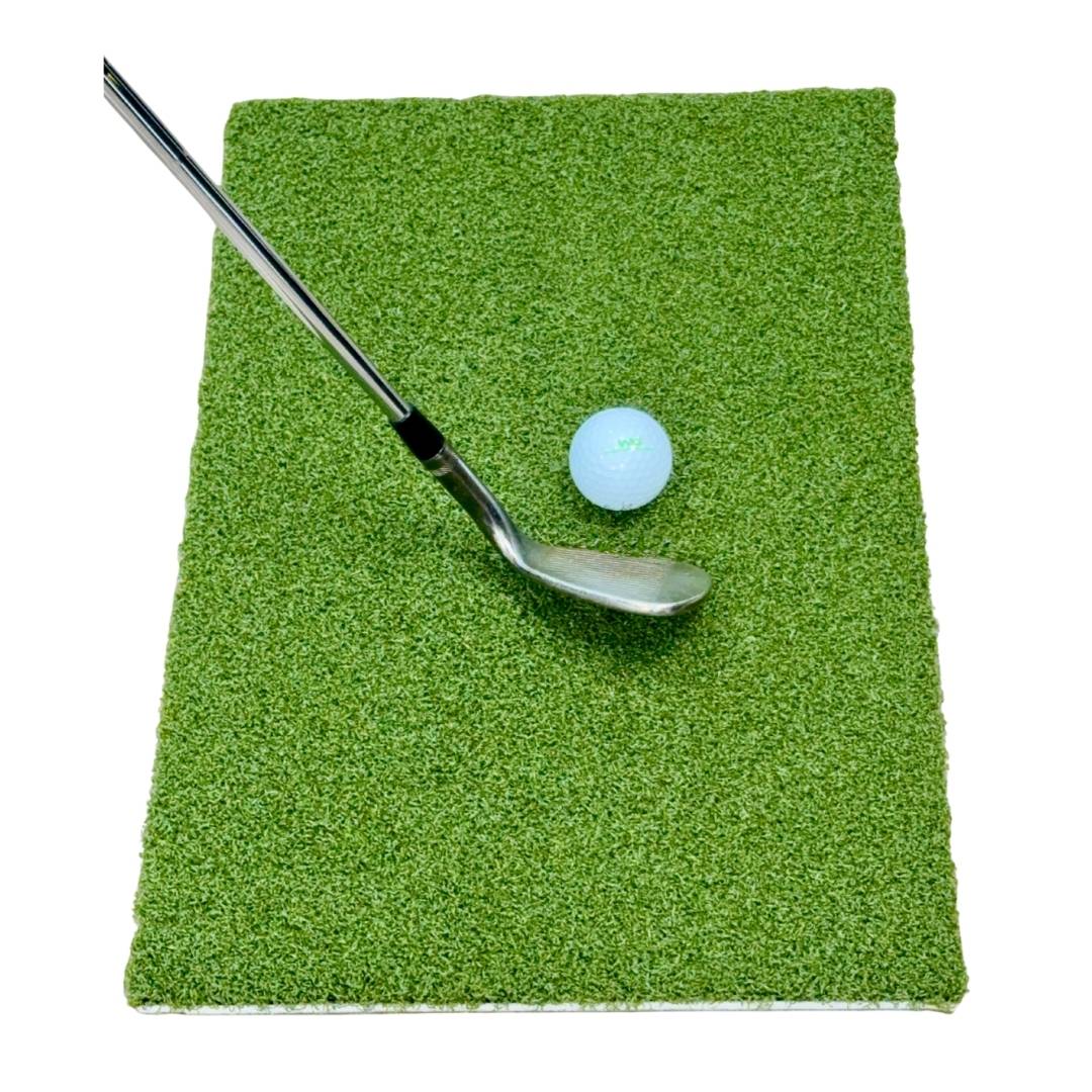 Golf club and ball on a green practice mat