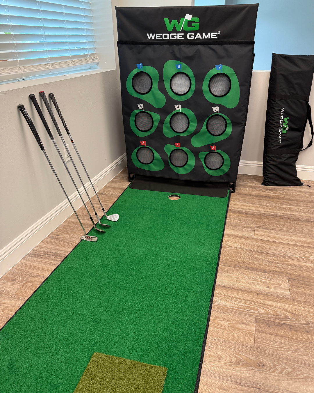 Golf wedge practice mat with golf clubs and Wedge Game branding indoors