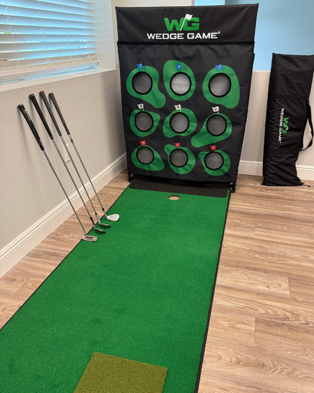 Golf wedge practice mat with golf clubs and Wedge Game branding indoors